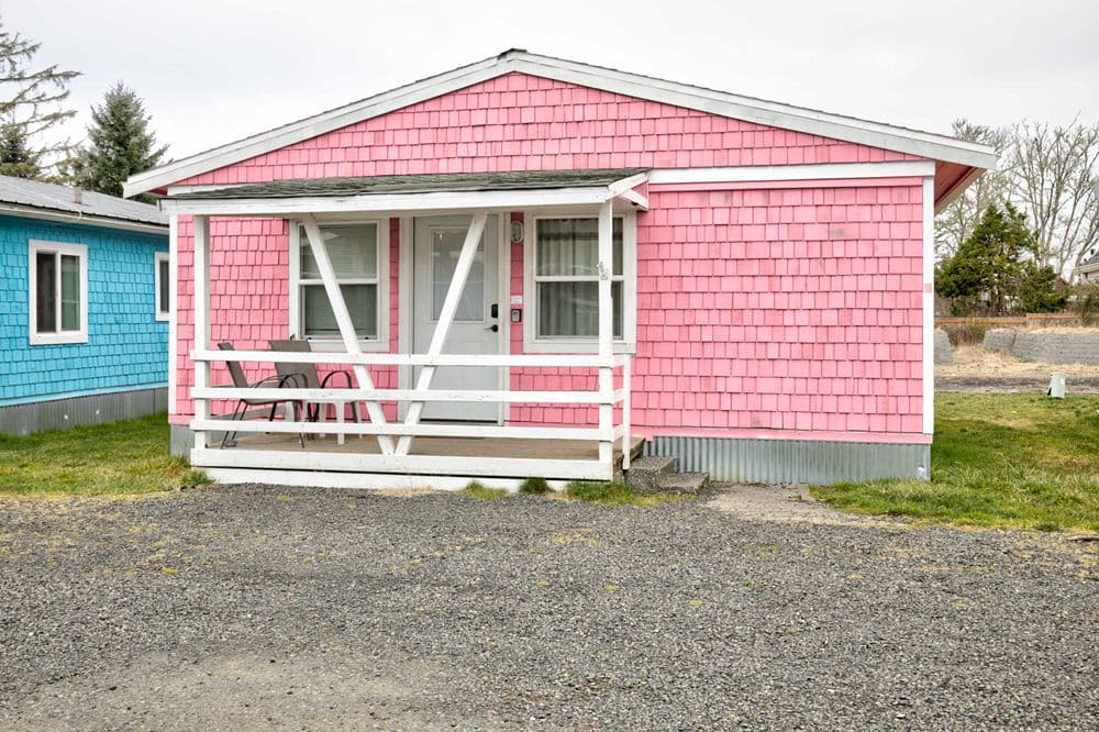 Cottage 4 exterior — pink shingle cottage with covered porch