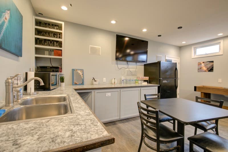Media room with large TV and kitchen bar